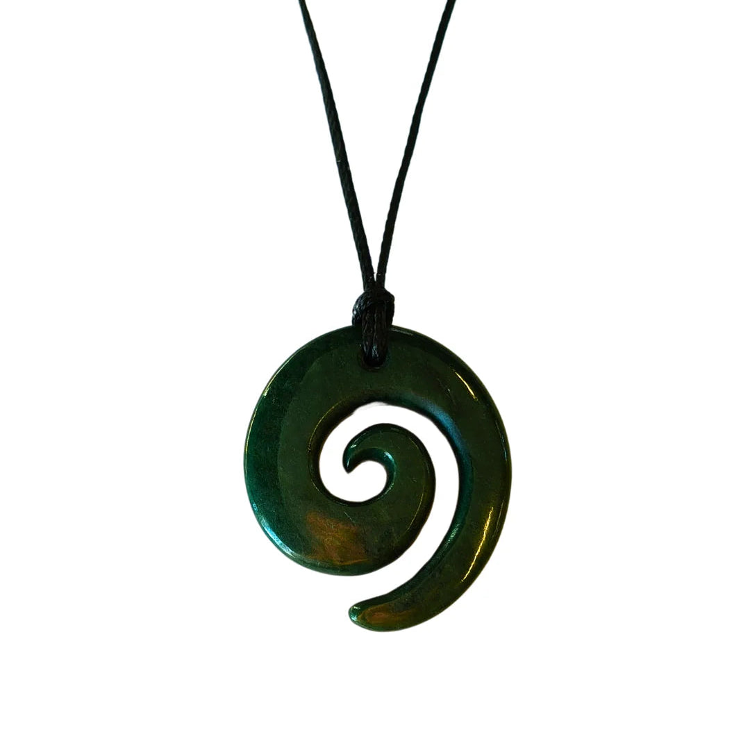 Green spiral pendant on a black cord against a white background