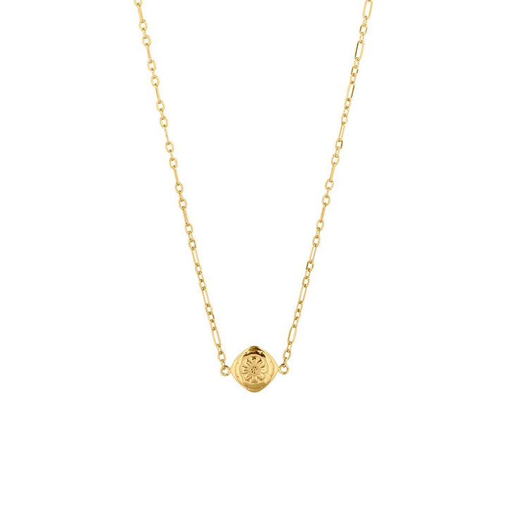 A gold plated necklace with a floral design pendant in the center
